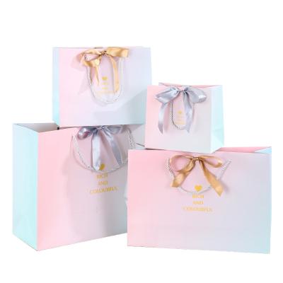 China New Design 2022 Recyclable Custom Printed Crosshair Colorful Luxury Gift Paper Bag With Silk Ribbon for sale