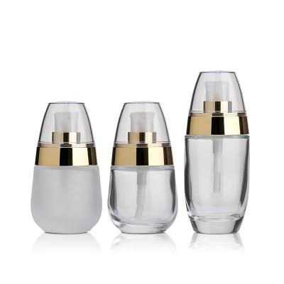 China Cosmetic Glass Rollball Bottles Transparent Cover Clear Light Liquid Foundation Pump Head Press Bottle 30ml Cosmetic Bottle for sale