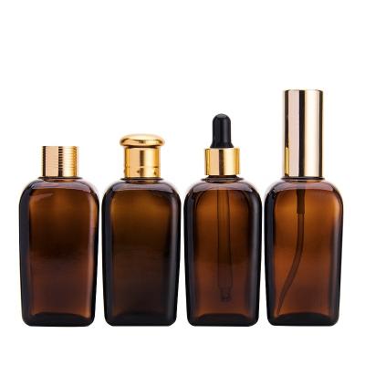 China 100ml square jar cosmetic glass bottle and jar jar gold inner concave brown cosmetic luxury glass rolling cap cosmetic glass bottle for sale