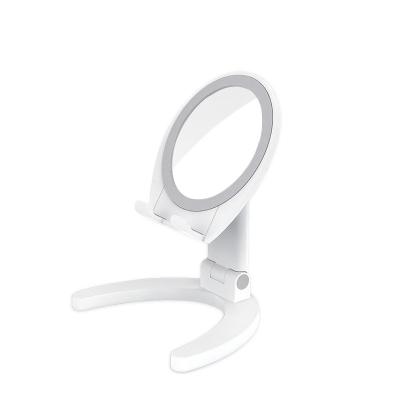 China New Next Double Sided Round Mirror With Phone Holder Table Folding Cosmetic Mirror With Phone Holder for sale