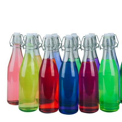 China Sustainable Home Glass Beverage Drinking Dispenser Sway Top Glass Water Juice Bottle for sale