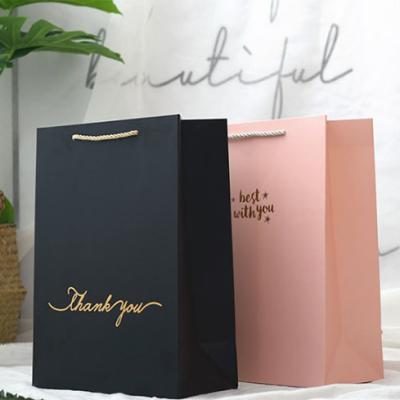 China Luxury Garment Garment Kraft Paper Bag With Customized Logo Black Shopping Bags On Sale for sale