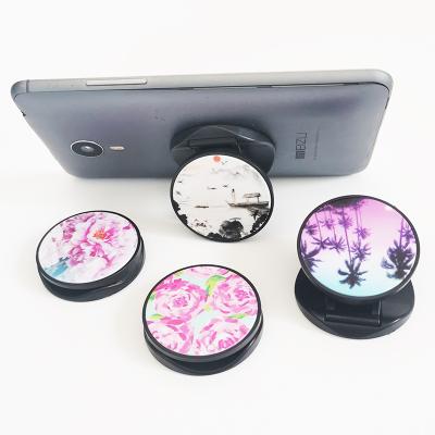 China Adjustable Wholesale Custom Popular Cell Phone Folding Plastic Round Phone Holder for sale