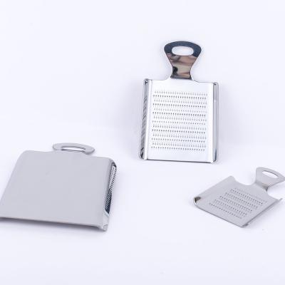 China Viable Kitchen Accessories Shovel Forming Stainless Steel Cheese Grater Flat Dish Garlic Ginger Grater for sale