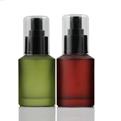 China 30ml 60ml Cosmetic Glass Red Green Frosted Cream Lotion Pump Bottle For Makeup Emulsion Toiletries Liquid for sale