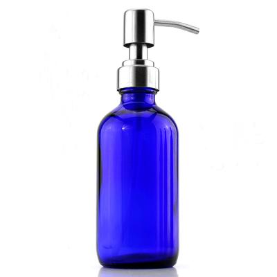 China Personal Care 8OZ Cobal Blue Glass Bottles With Stainless Lotion Pumps for sale