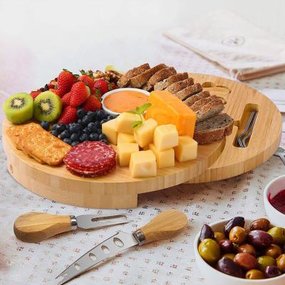 China Sustainable Bamboo Cheese Board Round With Ceramic Bowl Cheese Cutter Deluxe Cheese Board Set for sale