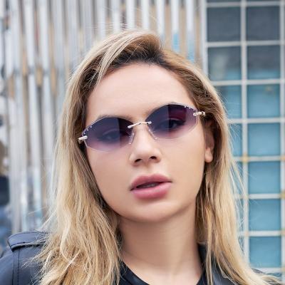 China Fashion Sunglasses Ocean Rimless Rimmed Lenses For Women Small Frame Irregular Sun Glasses For Women for sale