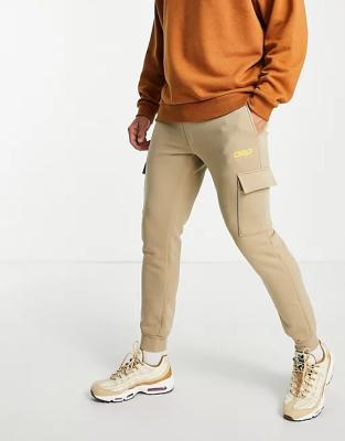 China Flat Cargo Flat Jogger In Slim Beige Elastic Waist Pockets Functional Logo Print, Tapered Fit Sweatpants for sale