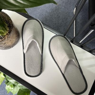 China Lightweight Custom Made High Quality Plush Gray Edge Disposable Hotel Pull Slippers for sale