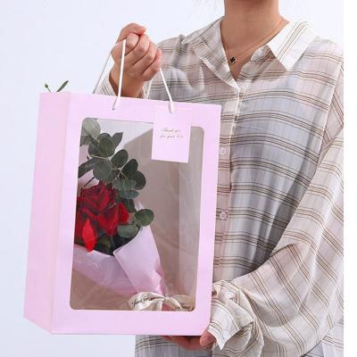 China Recyclable Waterproof Flower Paper Bag Bouquet Gift Handbag With Clear PVC Window for sale