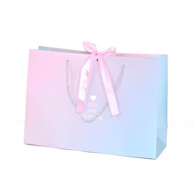 China Recyclable Custom Logo Print Luxury Pink Boutique Wedding Gift Packaging Paper Bag With Ribbon for sale