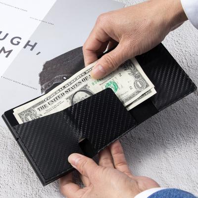 China RFID 2021 Pop Magnetic Card Money Holder Metal Wallet Real Carbon Fiber Leather Purse for sale