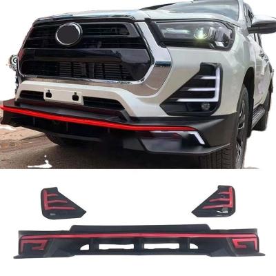 China 2022 Auto LED Light Body Kit Sport Spoiler Bumper Bar Front Bumper Lip Guard With Led DRL Turn Lamp For Toyota Hilux Revo 2021 for sale