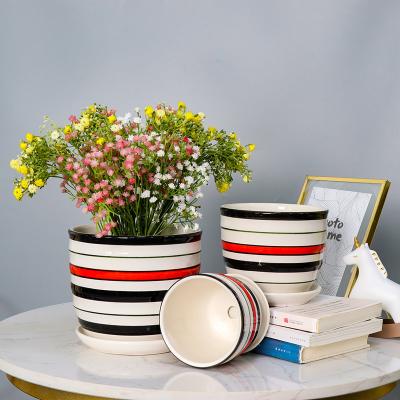 China Contemporary OEM Red and Black Lines Ceramic Look Fiber Clay Urn for Patio Decoration Flower Pots and Planters for sale