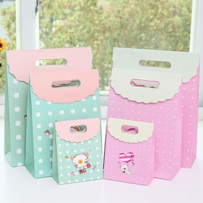 China Recyclable in Stock Cute Pig and Bear Cartoon Children's Day Gift Paper Bag with Die Cut Handle for sale