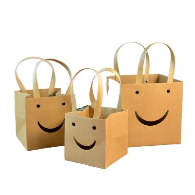 China Kraft Brown Reusable Dark Smile Face Tote Bag Wide Bottom Square Paper Bags for sale