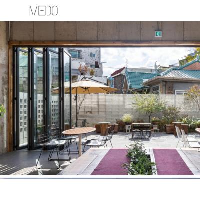 China Heat Insulation Aluminum Alloy Sliding Folding Door With Hinge Fire Proof Bi Fold Heavy Loading Door For Patio for sale