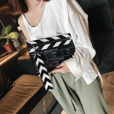 China Wristlet Clutch Bag Design Movie Cut Action Scene Cool Flapper Panel Shape PU Clutch Bag For Women for sale