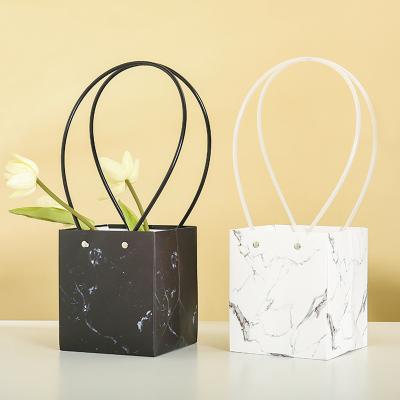 China Recyclable Custom Print PVC Long Handle 230gsm Ceremonial Marble Flower Carry Paper Gift Packaging Bag for sale