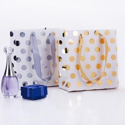 China Mini Holiday Christmas Ladies Girls Recyclable Gold Wholesale Silver Polka Dot Stamped Gift Bags for sale