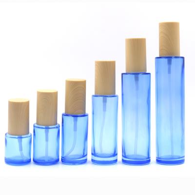 China Fancy Pump Bottle Personal Care Lotion Bottle Light Blue Color Glass Bottle Pump Dispenser Stock Goods for sale