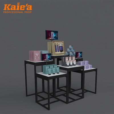 China Unique cosmetic shop makeup display unit display table black metal nested makeup display stand for sale