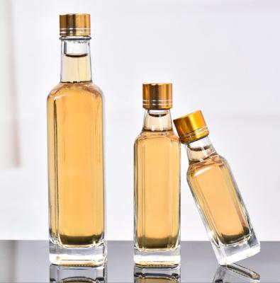 China Glass Olive Oil Bottle 100ml 250ml 500ml Round Clear Cooking Oil Bottle with Cap for sale