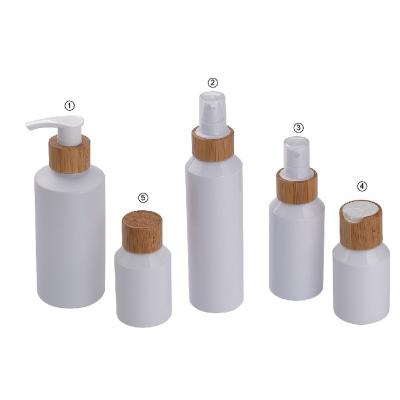 China PET cosmetic 30ml pump bottle with bamboo lids for skin care for sale