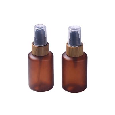 China 2oz cylinder empty plastic lotion bottles with bamboo lids for sale