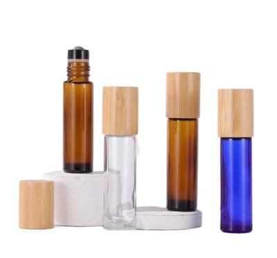 China 10ml 15ml clear blue amber glass roll on bottle with bamboo screw cap for sale