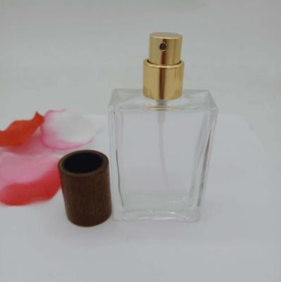 China Empty Atomizer Spray Perfume Oil Glass Bottle with Gold or Silver Cap and Wood cap for sale