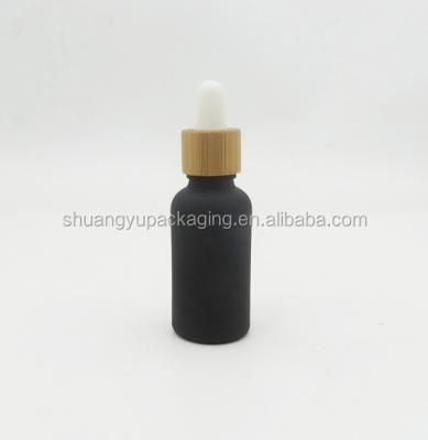 China Frosted black oil bottle with bamboo dropper essential oil bottle for sale