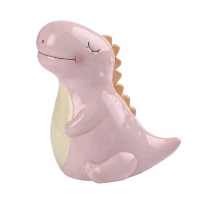 China Beautiful and Useful Custom Made Funny Pink Dinosaur Shaped Ceramic Coin Piggy Bank for sale