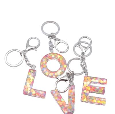 China Custom Plastic Bag Key Chain Resin Crystal 26 Initial Letters Keychain Charm, Sequin Heart Shape Gold Key Chain Acrylic Key Holder for sale