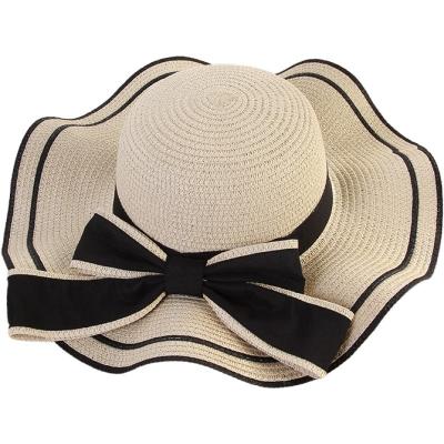 China Large Striped Outdoor Summer Hat Bow Beach Shade Wavy Brimmed Straw Hat for sale