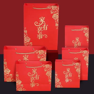 China Handmade Custom Paper Handbag With Logo Print Paper Red Handle Luxury Gift Bags With Logo for sale