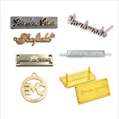 China Custom Metal Brand Metal Logo Embossed Antique Brass Bronze Alloy Apparel Metal Embossed Label Sewing On for sale