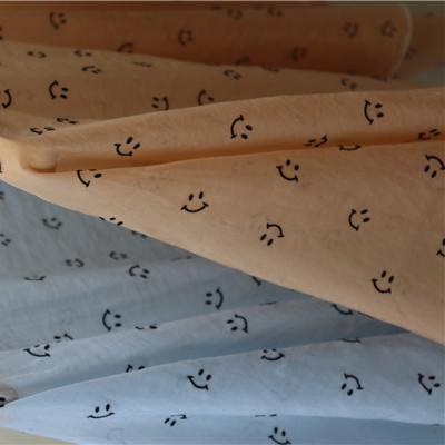 China Newest Selling Anti Pill Smile Emoji Flocking Fabric Exclusive Comfortable Fabric For Garment for sale