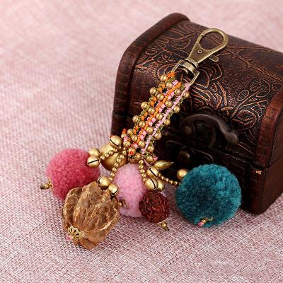 China New Bohemian style YCK069 unisex retro unisex Bohemian style metal wad cards key chain lobster buckle hair ball bronze pendant for sale