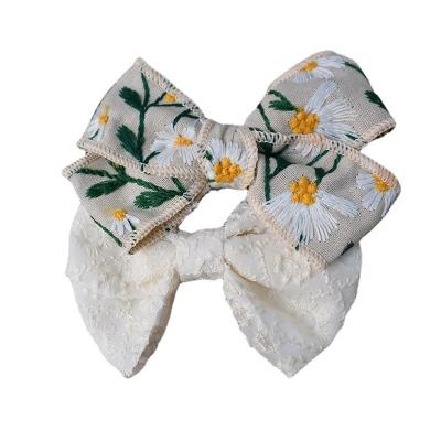 China Custom Size and Design Girls' Hair Decoration Embroidery Daisy Flower Hair Bow for sale