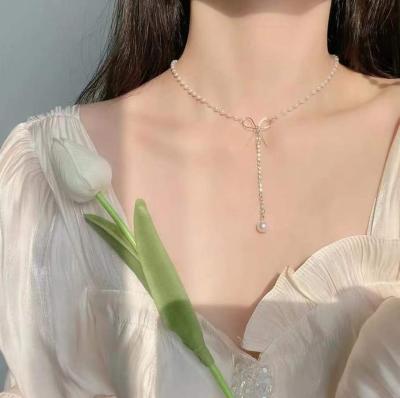 China FASHIONABLE Unique Shiny Bowtie Design INS Pendant Necklace CZ Pave Zircon Bow Knot Pearl Necklace For Women for sale