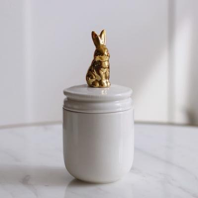 China Sustainable Ceramic Gold Shape Rabbit Bird Animal Food Storage Bottle Candy Tank With Lid for sale