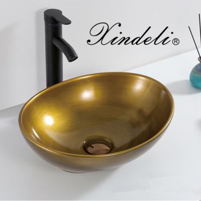 China Modern Sanitary Ware Luxury Oval Ceramic Bathroom Golden Ware Small Hand Lavatory Sink Sinks for sale