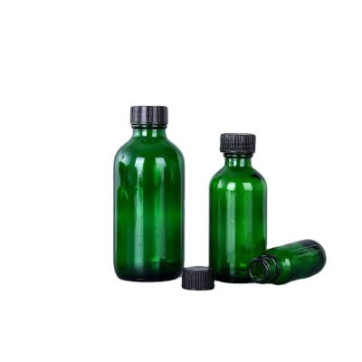 China Customizable Green Personal Care Pill Bottles Glass Medicine Bottle With Black Phenolic Cap for sale