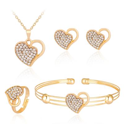 China Hot Sale Ethnic Amazon Four-piece Alloy Diamond Hollow Double Heart Necklace Earrings Ring Jewelry Set for sale