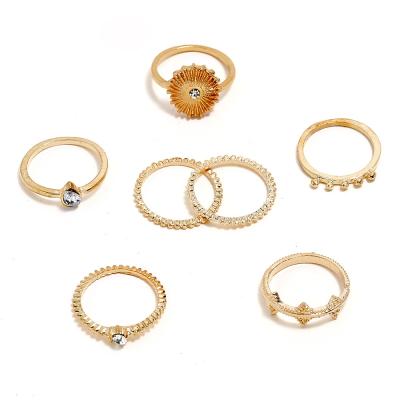 China Trendy Rounding Rhinestone Crystal Gold Plated Multilevel Arthrosis Rings Set For Women On Newspaper for sale