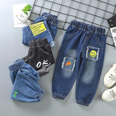 China Boys and girls waterproof children's jeans ripped pants children's casual pants for sale