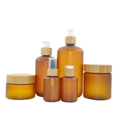 China 60ml 120ml 250ml 500ml Cosmetic Amber Frosted Plastic PET Pump Lotion Bottle With Bamboo Lid For Shampoo for sale