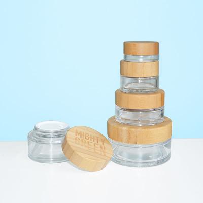 China 5ml 15ml 30ml 50ml 100ml cosmetic clear frosted glass jar with bamboo wooden lid for body cream for sale